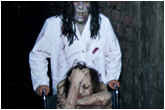 Photo of a scary mental patient being pushed in a wheelchair by another scary mental paitent
